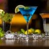 three cocktail glasses on wooden table